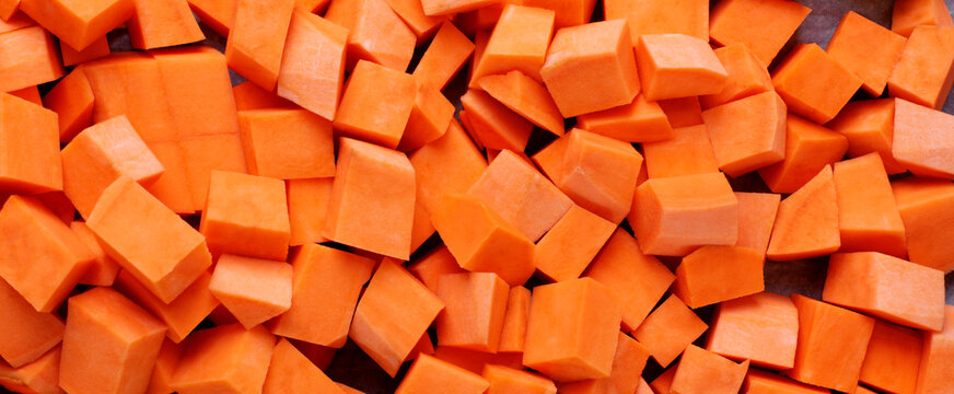 Web banner with diced sweet potato. Ingredient for a meal. Food texture 