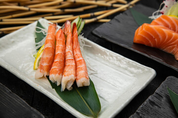 Assorted sashimi on a dark table
