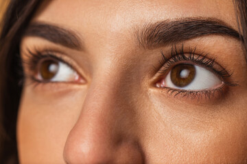 Fototapeta premium Close-up female face. Beautiful eyelashes and eyebrows. Concept of natural beauty, cosmetics, anti age treatment, wellness