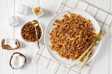 Coconut Rice with raisins on a plate, top view