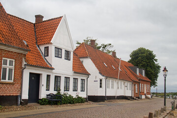 Cobblestoned street with red and white houses and red tiled roofs in Ribe, Denmark