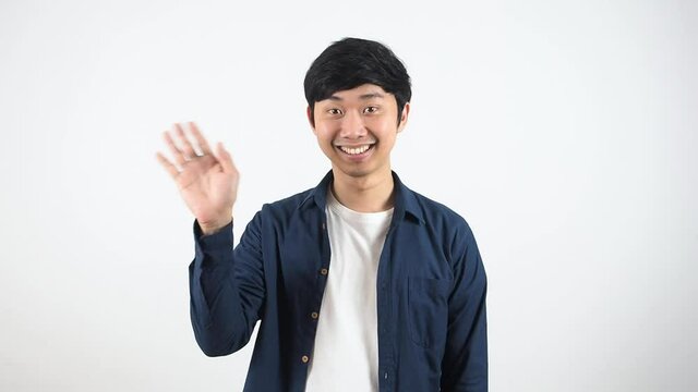 Asian man standing and show hand bye-bye, Man say good bye concept