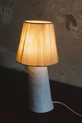 Stylish burning night lamp on table indoors. Light electric for interior home.