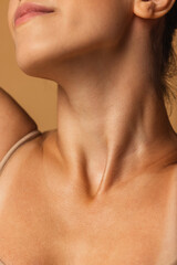 Fototapeta na wymiar Close up female neck, collarbones isolated on pink studio background. Beautiful caucasian woman with well-kept skin.