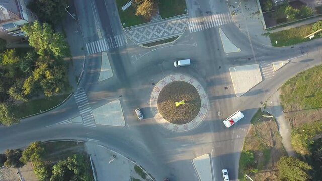 Asphalt road with a ring on which cars move from a bird's eye view. Traffic on a city road