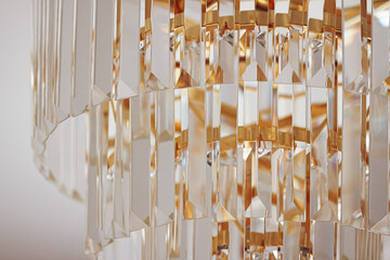 Crystal glass chandelier with golden details, luxury furniture and home decor concept