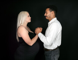 Stylish and happy multi-ethnic couple expecting a baby