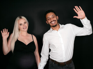 Stylish, proud and happy multi-ethnic couple expecting a baby