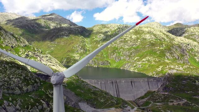 Windkrafträder und ein Stausee auf dem Gotthardpass in der Schweiz, (Luftaufnahme August 2021)