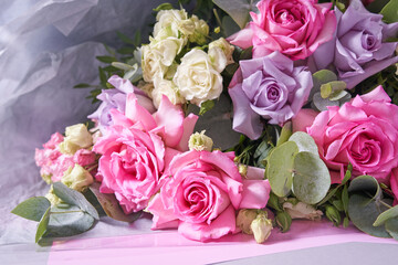 A large bouquet of flowers in close-up. Large pink roses. On a light background, top view. Horizontal composition. High quality photo