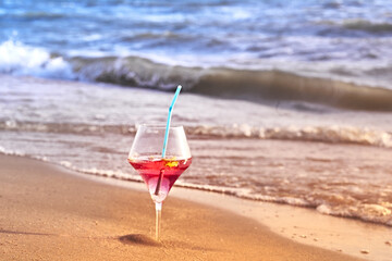 Wine glass with a cocktail by the sea.