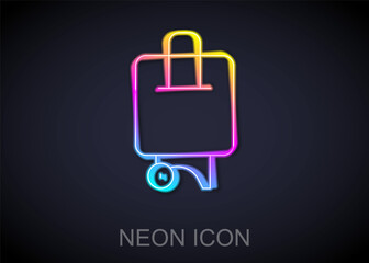 Glowing neon line Suitcase for travel icon isolated on black background. Traveling baggage sign. Travel luggage icon. Vector