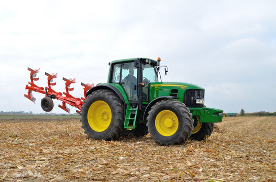 Skrzelew, Poland - October 09, 2011: Tractor-driver presenting a new model John Deere tractor (7530 series) with a reversible ploughs, during the XIII Days of Corn.
