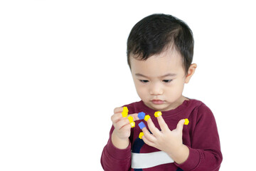 Asian children boy learn through play by putting toys on their fingers with white isolated background, child development concept.