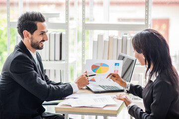 businessman talks to an African businesswoman or partner about the company's earnings or stock growth