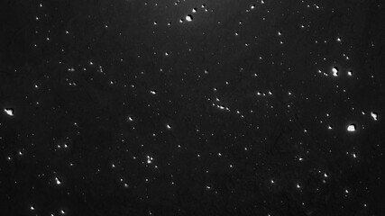 ざらざらとした印象の暗闇とパーティクルの背景