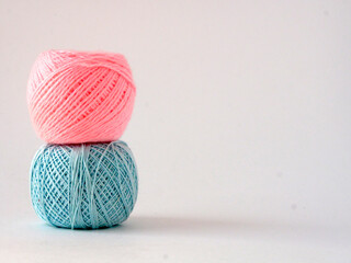 Knitting balls on white. Place for your text. Handicraft concept. Items on the left. 