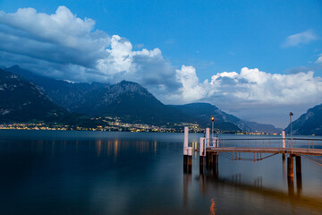 Night view of Lake Como and the cloudy mountains of Vasenna and boat pier