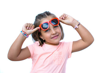 Portrait Of Girl On White Background. Little Girl Of 6 Years Caucasian Has Blue Eyes. Image With Copy Space. Pretty Girl With Red Glasses And Cheerful
