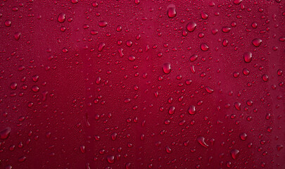 Drops of water on red surface. Macro photo, drop, shadow