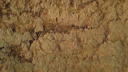 Grunge rustic vintage relief of ancient path. Uneven aged scuffed dirty hard dry clay rocky floor trail. Crannied bumpy cragged land footpath. Spotted shabby rough craggy dust mud 3D medieval design