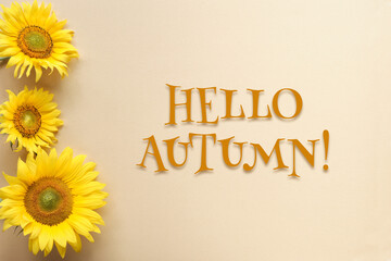 Hello Autumn, text with sunflowers on square flat lay. Beige, yellow paper background. Simple motivator for positive start of Fall season.