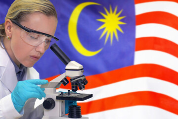 Female biochemist mixing substances to study under the microscope against Malaysia flag background. Medical technology and pharmaceutical research and development of science concept in Malaysia