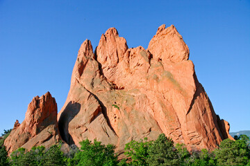 Fototapeta na wymiar Garden of the Gods Monolith - Huge red rock outcropping rises into the bright blue spring sky at the Garden of the Gods in Colorado Springs, El Paso County, Colorado