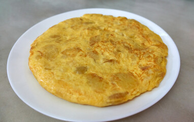 Spanish potato omelette plated on a white plate