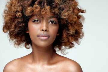 Beauty portrait of young attractive afro woman with perfect skin and delicate glamour makeup