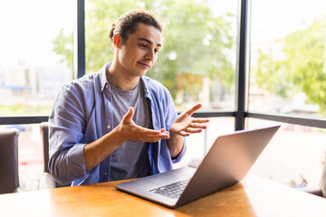 Man have business meeting via video call in a cafe