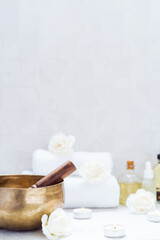 Spa and wellness massage setting with Tibetan singing bowl. Asian relaxing spa procedure with...