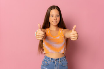 Teenager girl over isolated pink wall with thumbs up because something good has happened