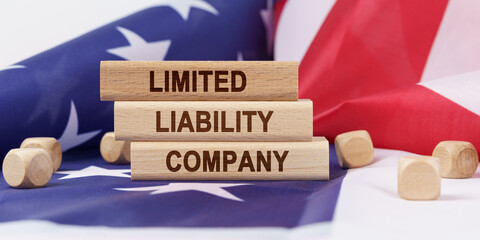The American flag has wooden cubes and plaques that say - LIMITED LIABILITY COMPANY
