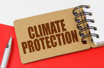 On the flag of Poland lies a notebook with the inscription - Climate protection