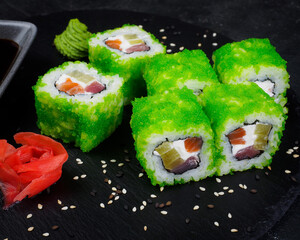 Japanese menu. Asian cuisine. roll with green tobiko caviar, daikon and salmon. sushi from fresh fish. healthy and proper nutrition concept. close-up.