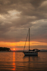 Dramatic rainy clouds during sunset over bay in Splitska on Brac island in Croatia.