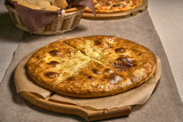 Ruddy closed pizza on a wooden tray