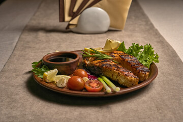 Salmon steak with sauce, vegetables and herbs