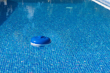Fototapeta na wymiar a pool chlorine dispenser floating in water
