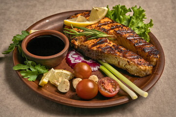 Salmon steak with sauce, vegetables and herbs