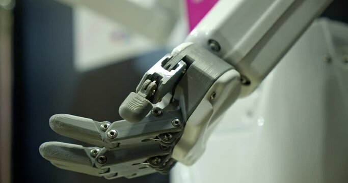 Close-up Of The Brush Of A Real Robot That Raises Its Hand. A Fragment Of The Cyborg's Body That Moves The Hand. The Latest Technologies In Reality And Everyday Life. Robot Arm At The Robot Exhibition