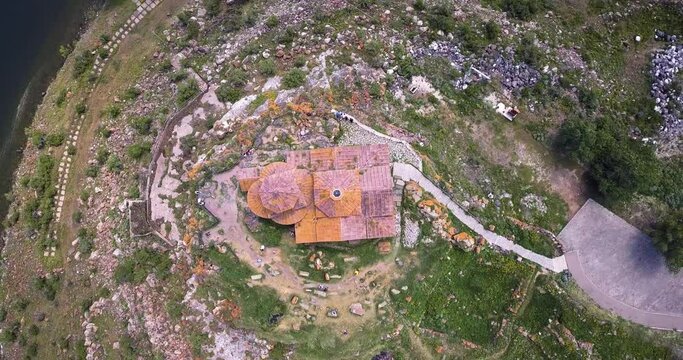 Top view of a drone flying with panning over the roof of the famous ancient monastery of Hayravank in Armenia
