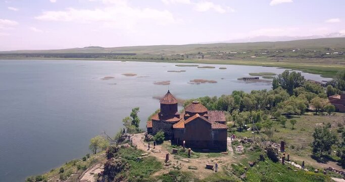 Video of a drone flying with panning over the famous ancient monastery of Hayravank in Armenia with the legendary Lake Sevan in the background