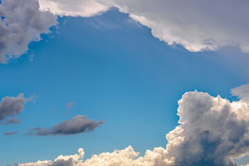 Fluffy White Clouds with Dark Clouds in Blue Sky