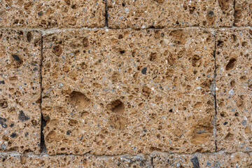 Wall made with many tuff bricks. Wall of tuff stone.