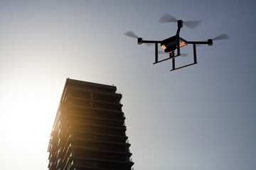 drone flying next to a building