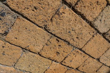 Fototapeta premium Wall made with many tuff bricks. Wall of tuff stone.