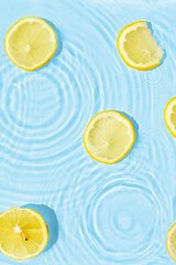 Abstract water texture with wet lemon slices, surface with drops, rings © photopixel