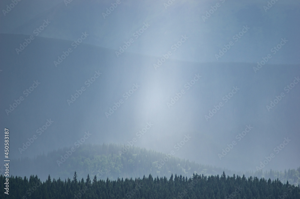 Wall mural sun rays and rain in the carpathian mountains in summer